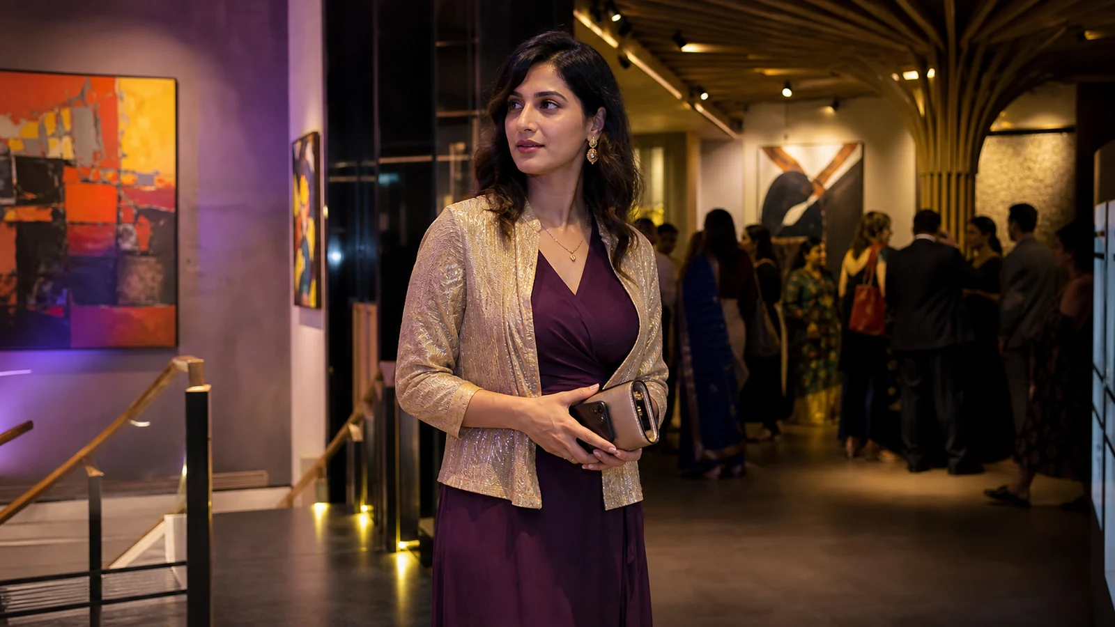 Clearly adult Indian model in a plum dress and gold jacket at a contemporary Bangalore art-gallery evening